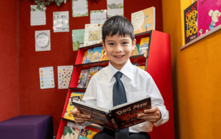 A photo showing a student from St Joseph’s Catholic Primary School Riverwood reading in the library